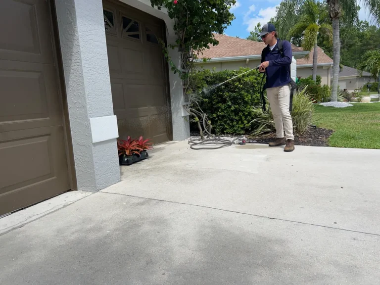 Professional pest control technician spraying treatment around home exterior and landscaping in Florida